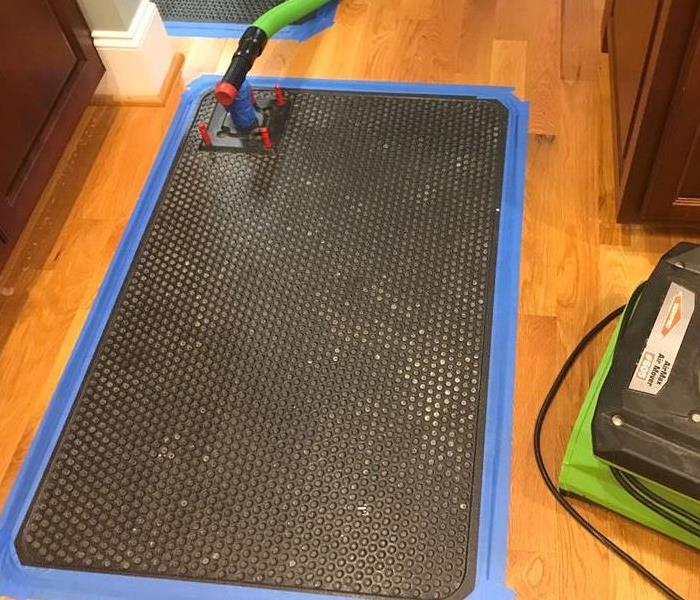 extraction mats placed to dry hardwood flooring 